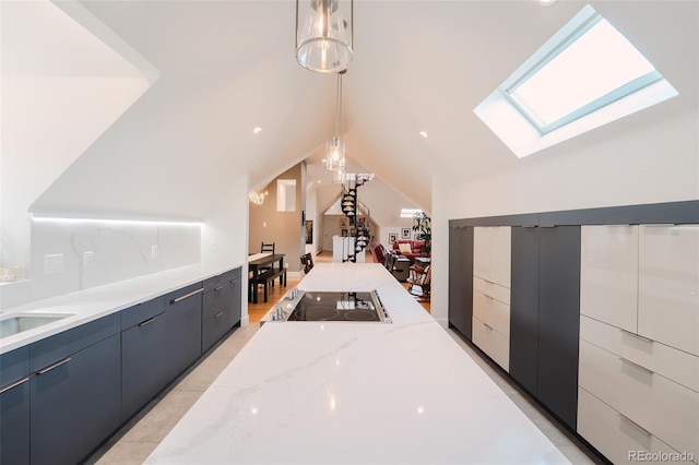 1165 N Pennsylvania St Unit 3B, Denver, CO 80203 - bar area with a skylight, black electric cooktop, hanging light fixtures, and lofted ceiling