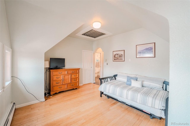 1165 N Pennsylvania St Unit 3B, Denver, CO 80203 - bedroom featuring baseboard heating, light wood-style floors, arched walkways, vaulted ceiling, and baseboards