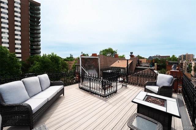 1165 N Pennsylvania St Unit 3B, Denver, CO 80203 - wooden terrace featuring an outdoor living space with a fire pit