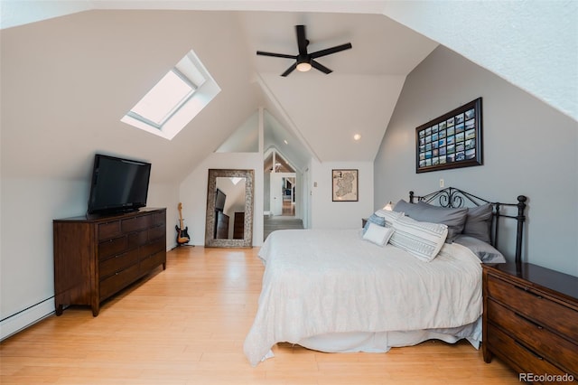 1165 N Pennsylvania St Unit 3B, Denver, CO 80203 - bedroom featuring a skylight, lofted ceiling, a baseboard radiator, light wood-type flooring, and a ceiling fan