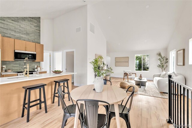 2600 S Downing St, Denver, CO 80210 - dining space with high vaulted ceiling and light wood-style floors