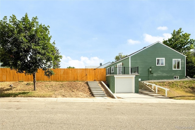 2600 S Downing St, Denver, CO 80210 - view of front of house with stairway, an attached garage, and driveway