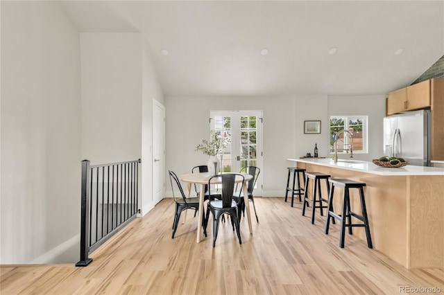 2600 S Downing St, Denver, CO 80210 - dining room with vaulted ceiling, light wood-style flooring, and french doors