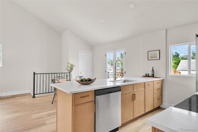 2600 S Downing St, Denver, CO 80210 - kitchen with stainless steel dishwasher, vaulted ceiling, a peninsula, light wood-style flooring, and light brown cabinets