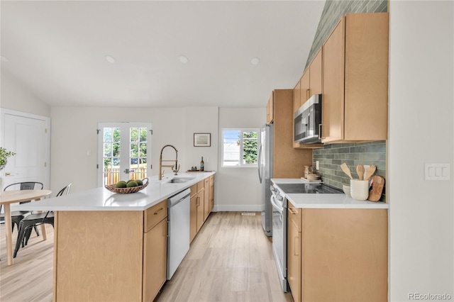 2600 S Downing St, Denver, CO 80210 - kitchen featuring stainless steel appliances, light wood-style floors, healthy amount of natural light, light countertops, and lofted ceiling