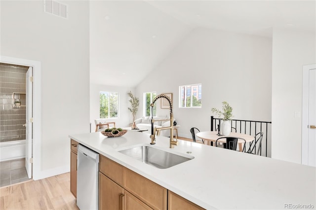 2600 S Downing St, Denver, CO 80210 - kitchen featuring dishwashing machine, light countertops, light wood-style flooring, high vaulted ceiling, and open floor plan