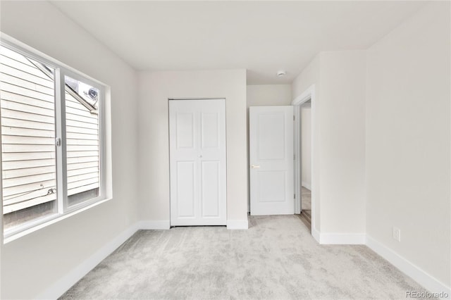 2600 S Downing St, Denver, CO 80210 - unfurnished bedroom with multiple windows and light colored carpet