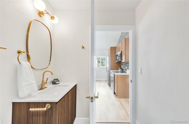 2600 S Downing St, Denver, CO 80210 - bathroom with vanity, wood finished floors, and backsplash