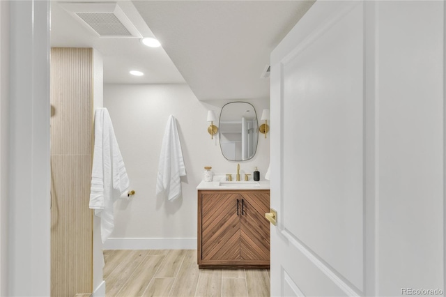 2600 S Downing St, Denver, CO 80210 - bathroom with wood finished floors, vanity, and recessed lighting