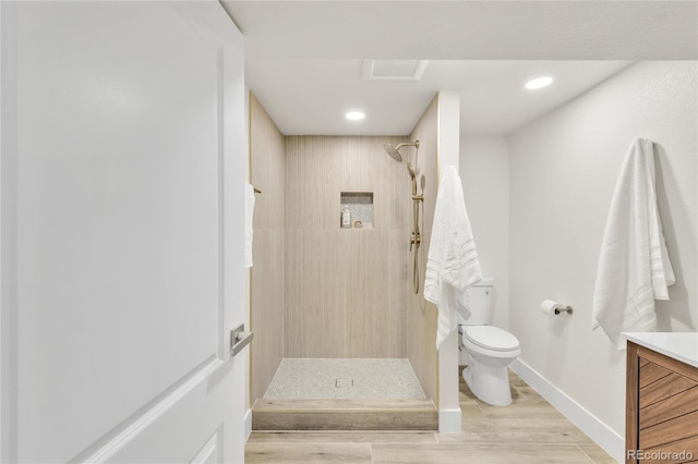 2600 S Downing St, Denver, CO 80210 - full bathroom with a shower stall, vanity, wood finished floors, and recessed lighting