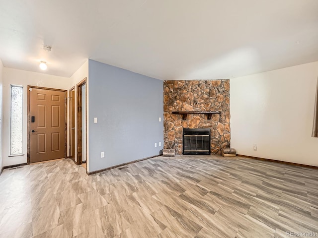 unfurnished living room featuring a fireplace and light wood-type flooring