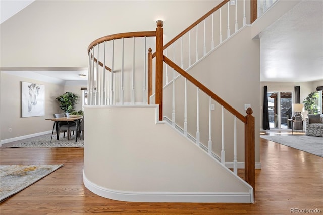 staircase with hardwood / wood-style floors