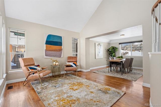 sitting room featuring vaulted ceiling and hardwood / wood-style floors