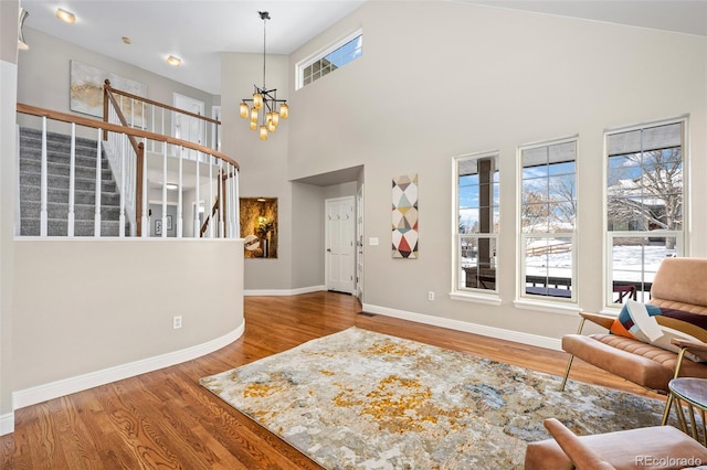 interior space featuring a notable chandelier, a high ceiling, and hardwood / wood-style flooring