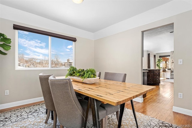 dining space featuring light wood-type flooring