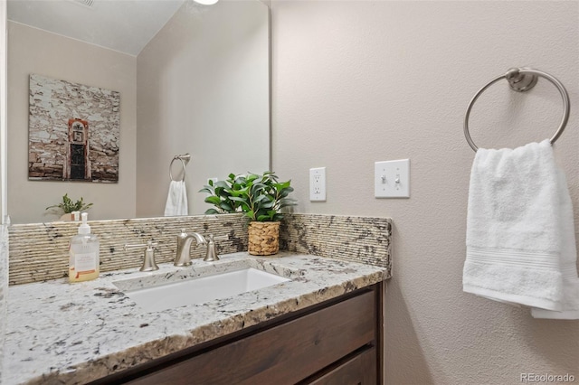 bathroom featuring tasteful backsplash and vanity