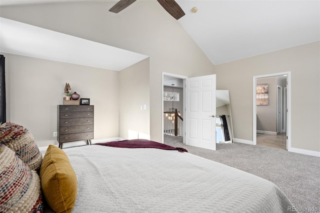 carpeted bedroom with ceiling fan and high vaulted ceiling