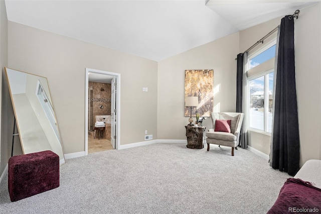 living area with lofted ceiling and light colored carpet