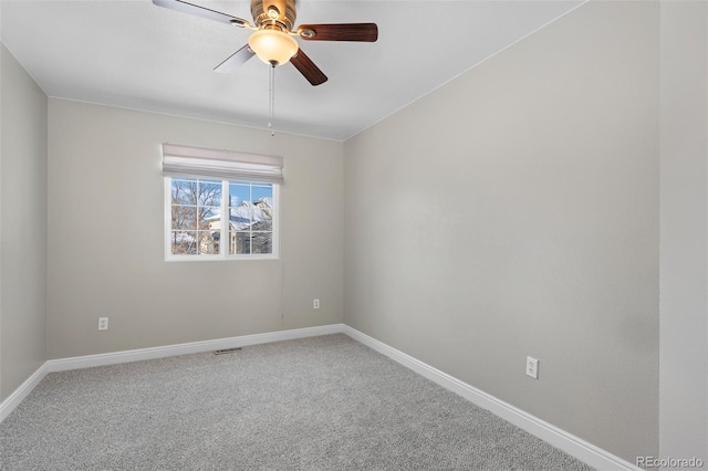 spare room featuring ceiling fan and carpet