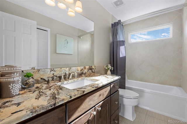 full bathroom featuring toilet, vanity, and shower / bath combo with shower curtain