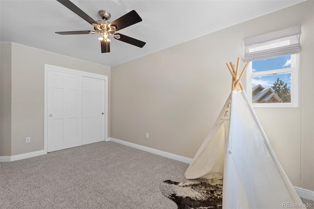 unfurnished bedroom featuring ceiling fan, a closet, and carpet floors