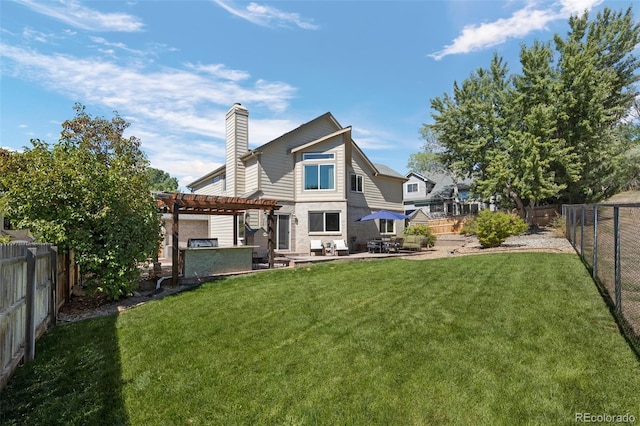 back of house with a pergola, a patio area, and a yard