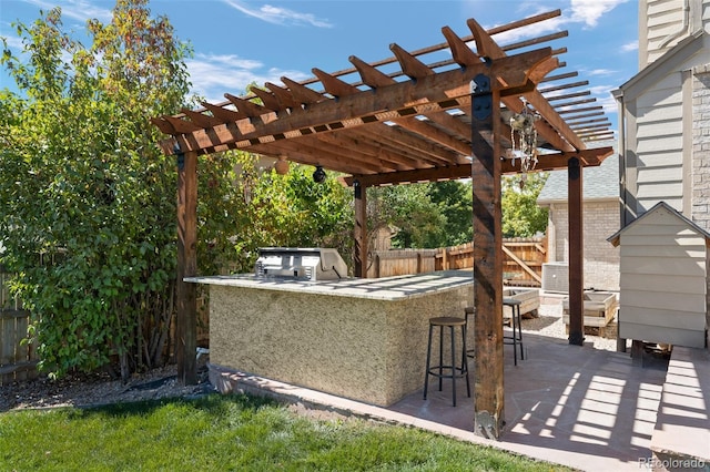 view of patio with a pergola, a grill, an outdoor kitchen, and exterior bar