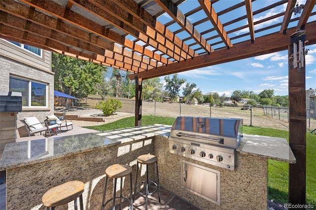 view of patio / terrace with an outdoor kitchen, a pergola, and grilling area