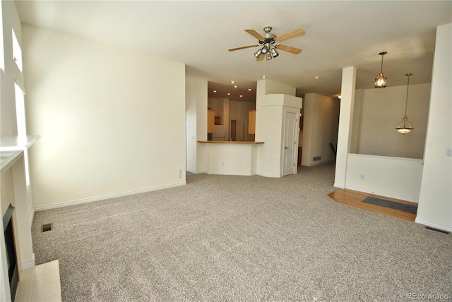 unfurnished living room featuring recessed lighting, a fireplace with flush hearth, light carpet, ceiling fan, and baseboards