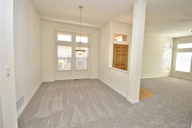 carpeted empty room with visible vents and baseboards