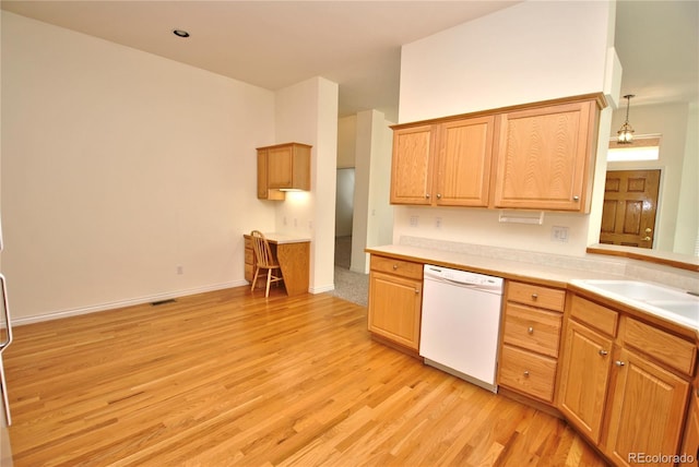 kitchen with light countertops, visible vents, light wood-style floors, white dishwasher, and a sink