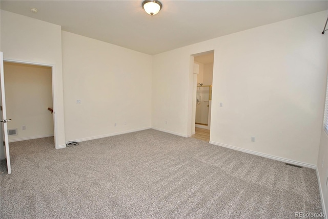 unfurnished bedroom with baseboards, visible vents, and light colored carpet