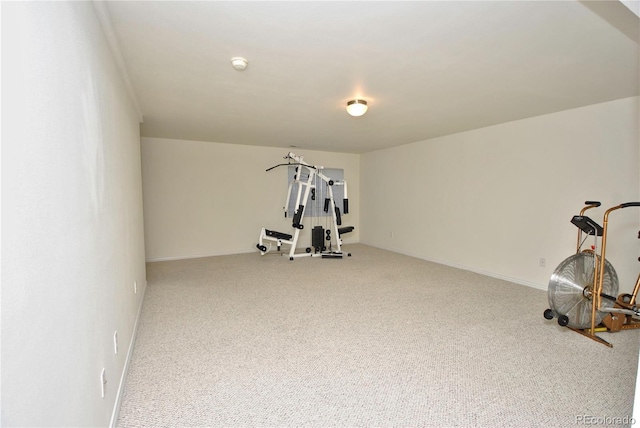 workout area featuring carpet floors and baseboards