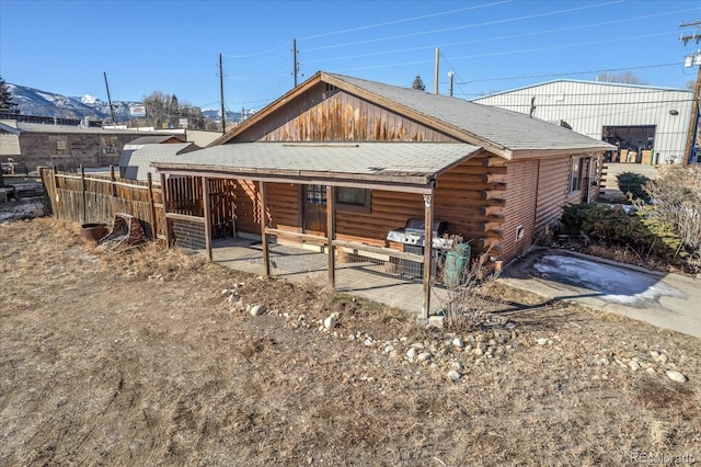 rear view of house with an outdoor structure