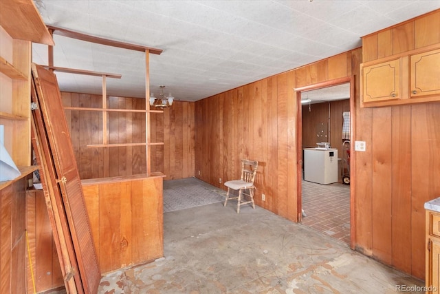 interior space featuring wood walls and washer / dryer