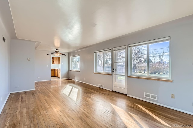 unfurnished living room featuring ceiling fan, wood-type flooring, and visible vents