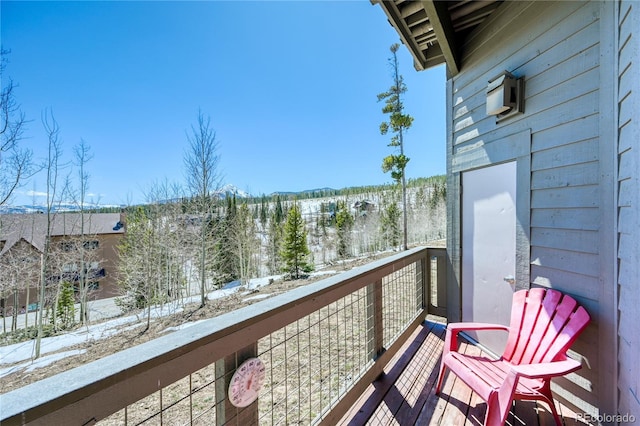 snow covered back of property with a mountain view
