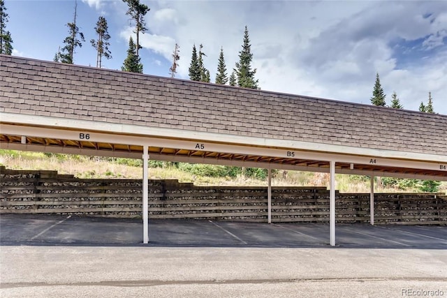covered parking lot with fence