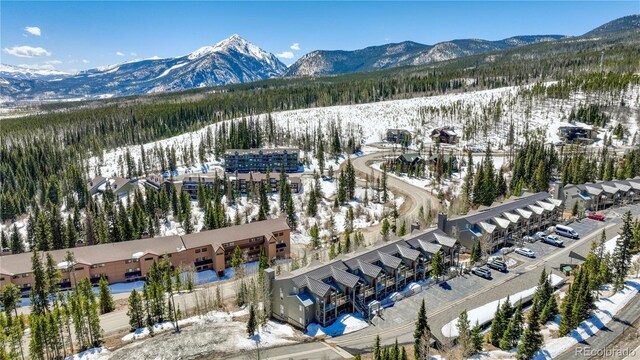 snowy aerial view with a mountain view