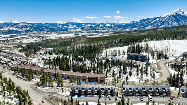 snowy aerial view with a mountain view