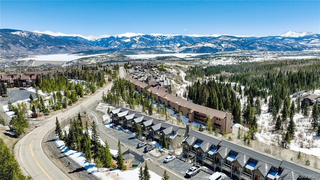 snowy aerial view featuring a mountain view