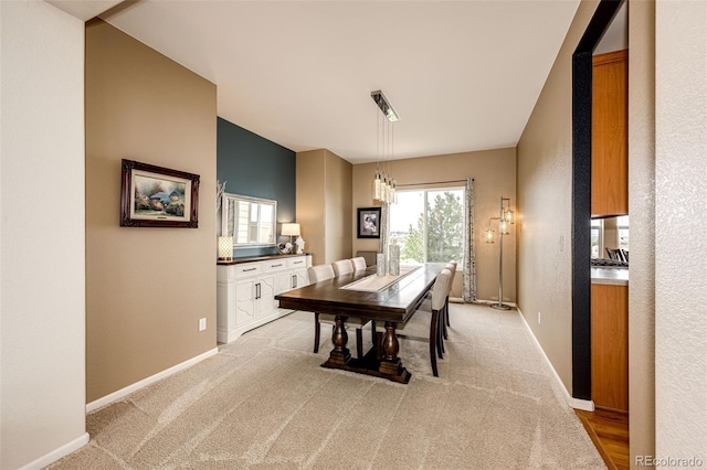 22962 Briar Leaf Ave, Parker, CO 80138 - dining room featuring baseboards, a chandelier, light colored carpet, and a textured wall