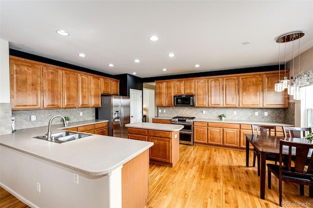 22962 Briar Leaf Ave, Parker, CO 80138 - kitchen with stainless steel appliances, a sink, light countertops, brown cabinets, and tasteful backsplash