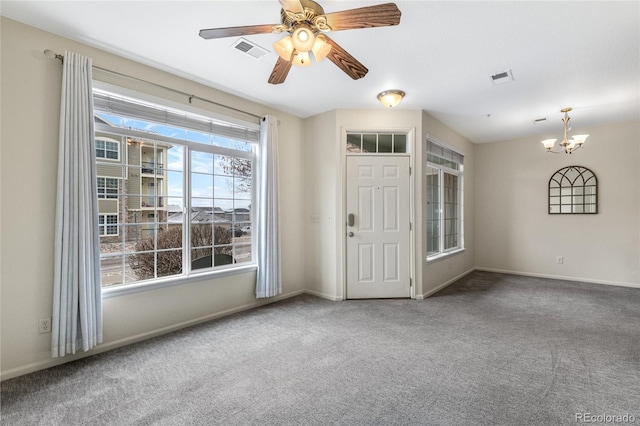 interior space featuring ceiling fan with notable chandelier