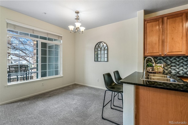 interior space featuring an inviting chandelier, sink, and carpet floors