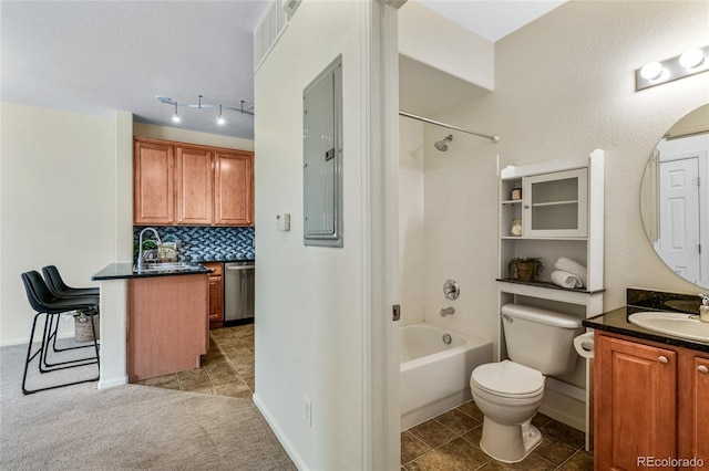 full bathroom featuring backsplash, electric panel, vanity, shower / washtub combination, and toilet