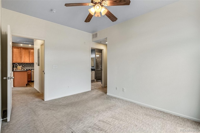 carpeted spare room with ceiling fan