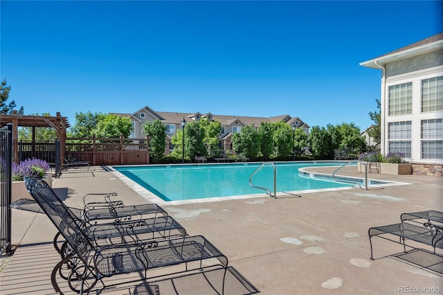 view of swimming pool featuring a pergola and a patio area