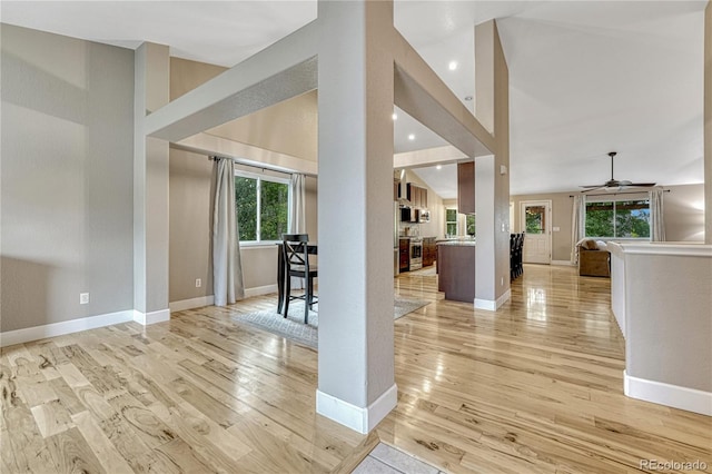5402 S Queen Way, Littleton, CO 80127 - foyer with light wood finished floors, plenty of natural light, a ceiling fan, recessed lighting, and a towering ceiling