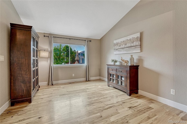 5402 S Queen Way, Littleton, CO 80127 - unfurnished room with vaulted ceiling and light wood-style floors